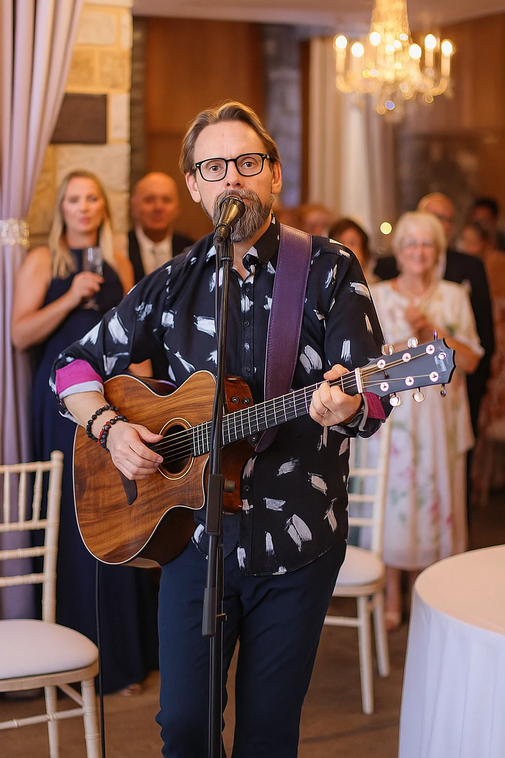 Shane Joseph singing and playing acoustic guitar at a wedding